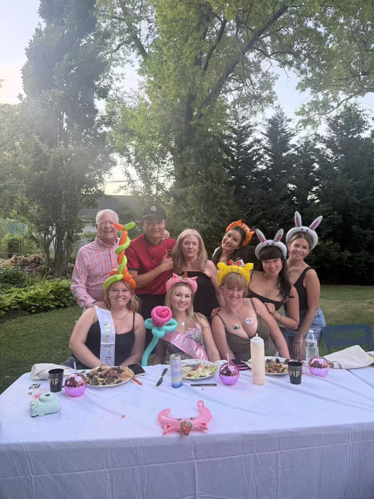 Garden Celebration Guests in party hats at a garden hibachi dinner in Connecticut